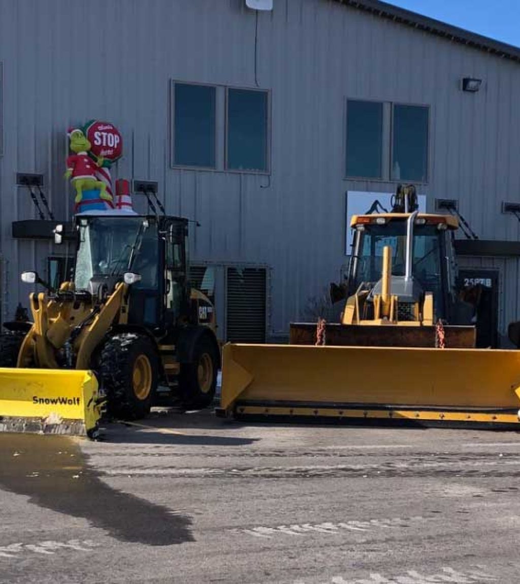 Large Bull Dozers to haul off snow for snow removal services.